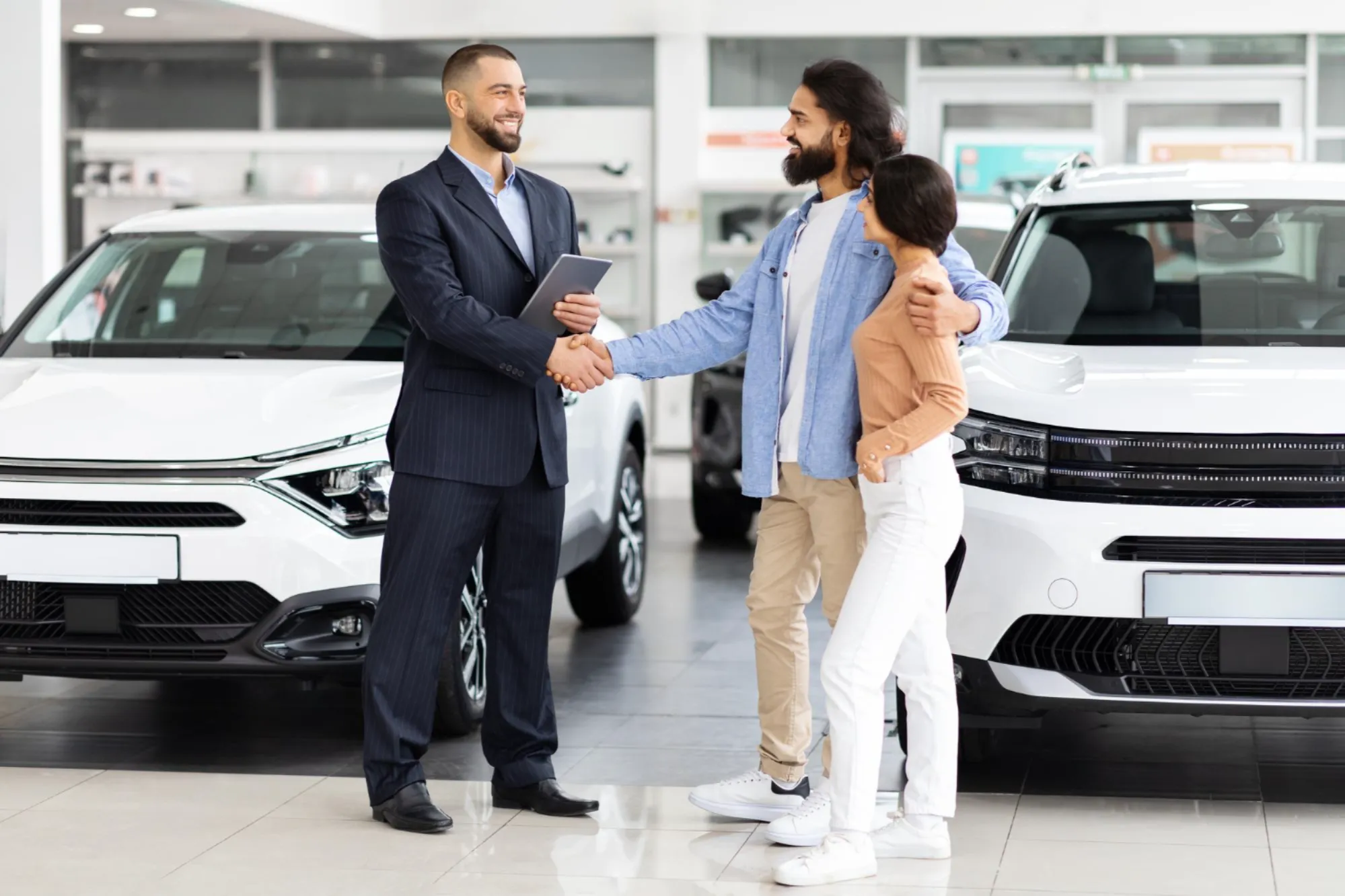 Couple purchasing an SUV at a dealership in Canada for winter driving with guidance from Value Car Deals