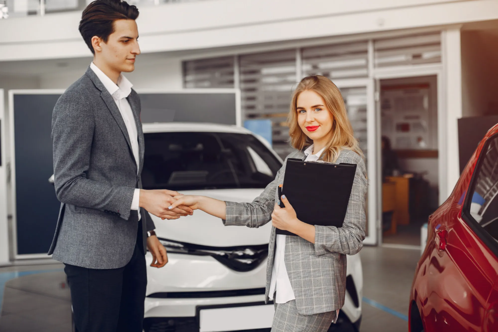 Car buyer reviewing inspection checklist with a dealership advisor before purchasing a vehicle in Canada at Value Car Deals